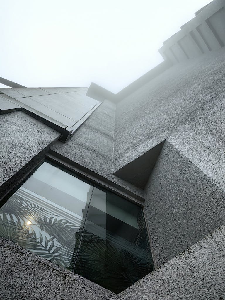 A modern concrete building facade set against a misty sky in Genting Highlands, Malaysia.